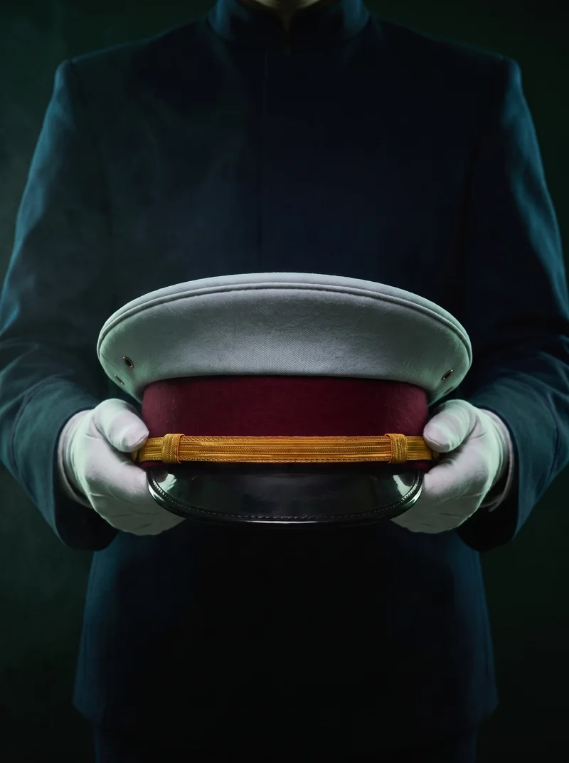 Officer presenting a formal dress cap