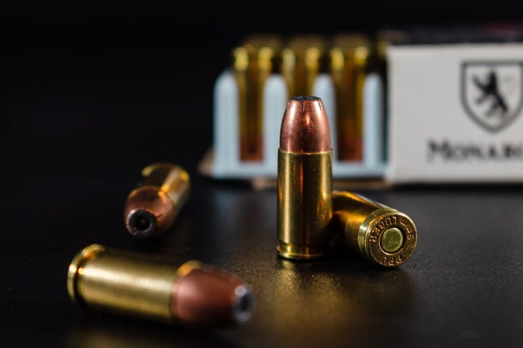 Detailed image of bullets with a focus on brass casing and box in background.